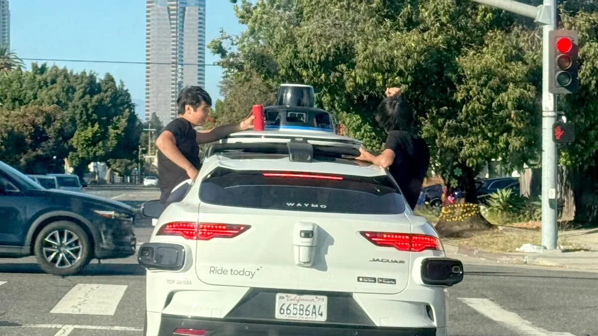 Waymo Car Carries Boys Riding in Open Windows